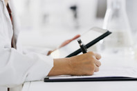 GettyImages-1464673521-tablet-scientist-paper-checking-pen-hand-writing