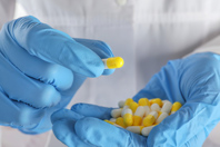 Doctor holding antibiotic pills-GettyImages-2271436785