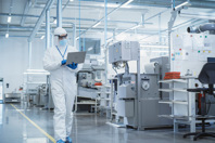 CDMO Accelerates Contract Manufacturing With Electronic Batch Records GettyImages-1462154865 Scientist Using Laptop In Manufacturing Facility
