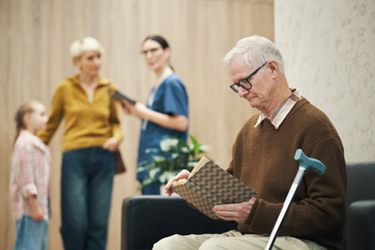 Senior Man with Disability Reading Book-GettyImages-2244142906