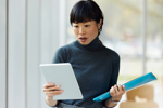 female looking surprised while reading tablet-GettyImages-2170919821