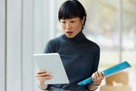 female looking surprised while reading tablet-GettyImages-2170919821