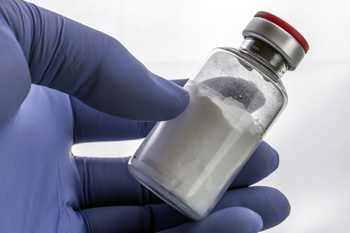 hand holding vial-GettyImages-951661874