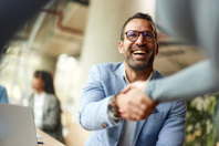 Businessman shaking hands with colleague-gettyImages-2184295789