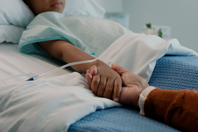 Hospital, holding hands and kid in bed, healthcare, cancer-GettyImages-2120554524