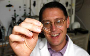 Benny Freeman of The University of Texas at Austin holds a sample of the transparent membrane material developed in his laboratory.

Credit: Jennie Trower, The University of Texas at Austin