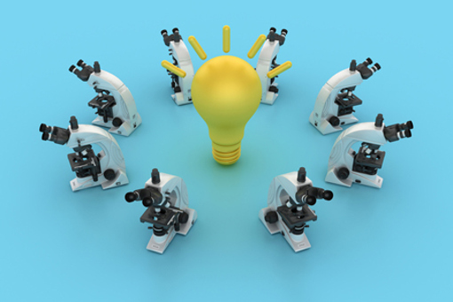 Circle of Microscopes with Light Bulb-GettyImages-2294487444