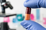 GettyImages-691189734-pill-analysis-microscope-gloved-hand