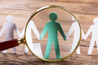 Magnifying Glass On Cut-out Figures-GettyImages-915461616