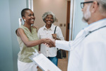 Mother abd adult daughter at doctors-GettyImages-2213748134