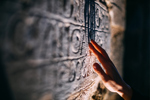 GettyImages-1481419356-archaeologist-ancient-inscription