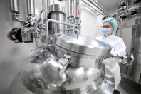 GettyImages-1405217666-mixing-vessel-in-pharmaceutical-lab-scientist