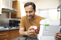 adult male checking delivered medicine-GettyImages-2284294341