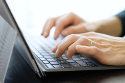 Asian man typing on laptop-GettyImages-1371907414