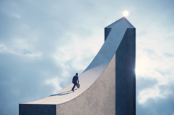 Business man running on arrow shaped bridge-GettyImages-1686497935