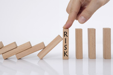 domino effect and risk management concept iStock-1272805554
