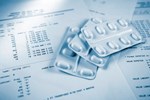 AstraZeneca, Pharmacyclics Ink 2 Oncology Partnerships pills on paperwork 450x300
