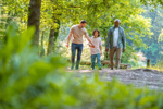 Diverse multigenerational family walking in a park
