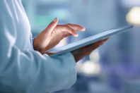A Modern Pharma MES Solution Offers The Best Of Old And New Scientist Using Tablet GettyImages-1413603540