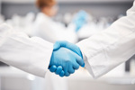 GettyImages-1589912225-scientists-shaking-hands-in-lab