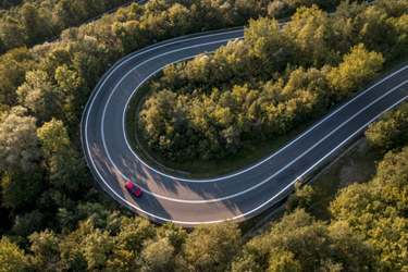 car on winding road-GettyImages-2157089736 car on winding road-GettyImages-2157089736