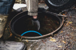 Is Trouble-Free Pumping Really Possible? GettyImages-918789198-sewer-well-hand-glove