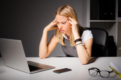 Business woman looking at laptop-GettyImages-503422576