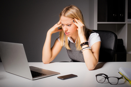 Business woman looking at laptop-GettyImages-503422576