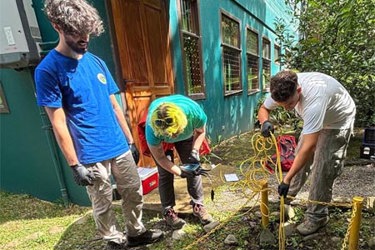 Jackson Anderson and Facundo Pereyra-Kluser collecting a water sample from a constructed wetland