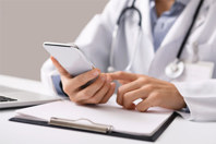 Commercializing Rare Disease Treatment With Near Real-Time Alerts GettyImages-1188648041-physician-doctor-phone-app