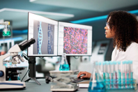 GettyImages-2203738408-computer-monitor-screen-gene-editing-lab-woman