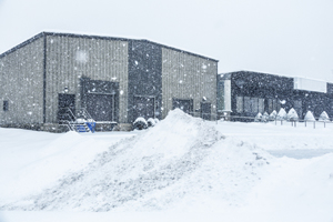How Can 3PL Warehouses Prepare For Winter? Blizzard Snow Storm Industrial Warehouse GettyImages-513587006