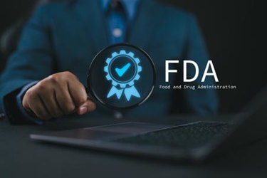 FDA icon on virtual screen for Health product standards control system-GettyImages-2218694245