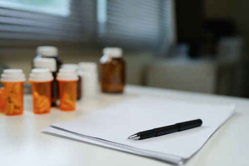 Blank paper, pen, medicine pills-GettyImages-2240684099