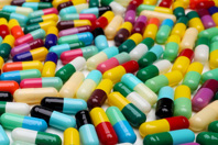 Over-Encapsulation/Blinded Study Materials colored oill capsules-GettyImages-1619922521