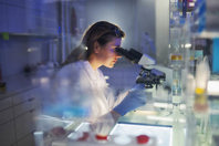 Expert-Guided Media And Buffer Formulation Services scientist laboratory microscope-GettyImages-1253518521