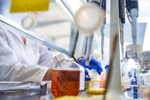 GettyImages-1213787059-scientist-in-laboratory-with-flasks-cell-culture