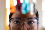 Scientist observing colorful liquid in test tubes-GettyImages-2158013158