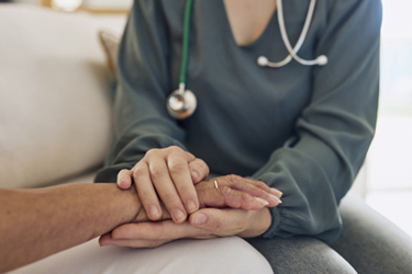 Doctor Holding a Patient's Hand-GettyImages-1887468058