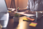 A Quality Agreement Primer: Reviewing Regulations & Enforcement Activity Businesswoman marking segments of a contract with a highlighter