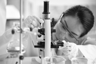 Woman adjusting microscope-GettyImages-2181295784