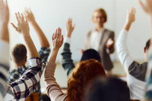 Students raising hands-GettyImages-1690372577