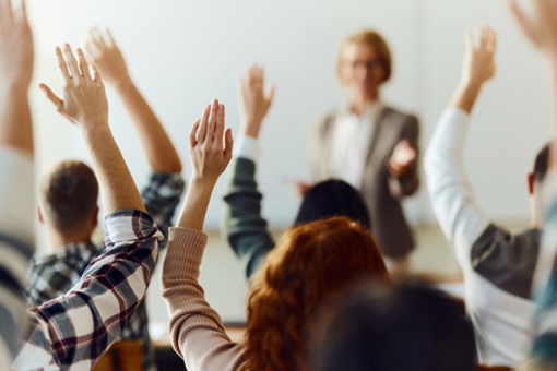 Students raising hands-GettyImages-1690372577