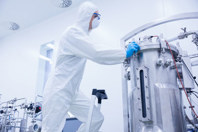 GettyImages-538088463-scientist-cleaning-maintenance-bioreactor