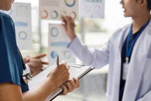 Doctors discussing patient data-GettyImages-2214031965