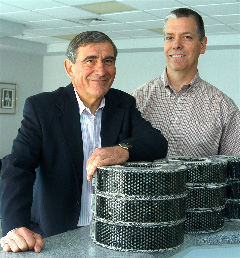 Klaus Peter, president of Rypos (left) and Kevin Nelson, marketing vice president of Purolator Facet announce manufacturing plans.