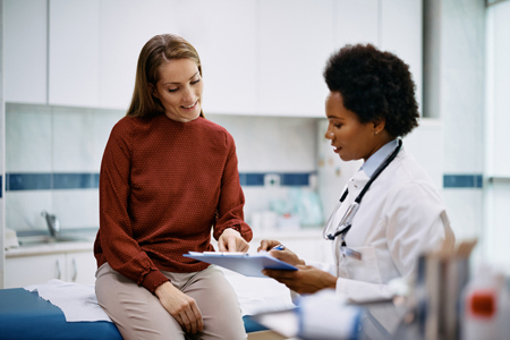 patient and doctor analyzing medical report-GettyImages-1461330630