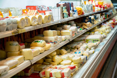 GettyImages-1497186874 Variety of cheese in supermarket dairy aisle