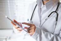 GettyImages-1316791903-doctor-with-tablet-in-office-hand