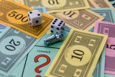 monopoly-car-dice-money-and-chance-square-iStock-537097883
